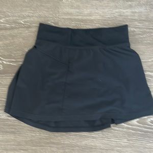 Black skirt with shorts underneath and is a size medium in kids girls